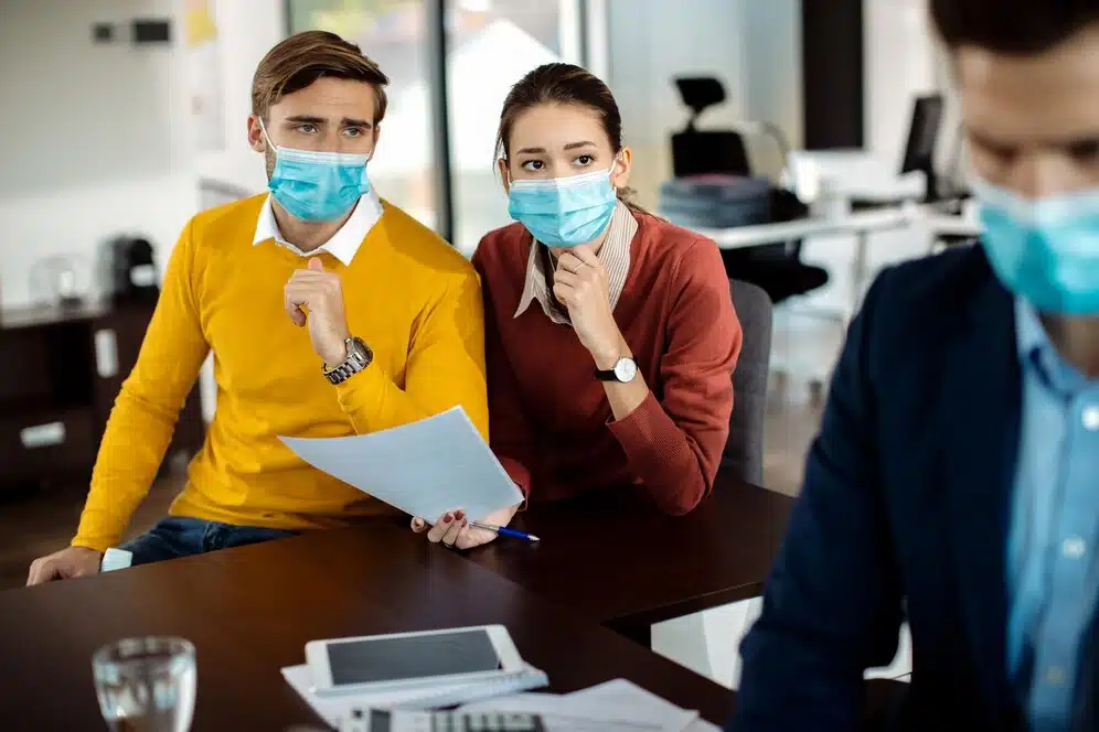 distraught-couple-analyzing-paperwork-while-having-meeting-with-bank-manager-coronavirus-pandemic_637285-10912